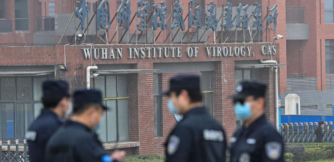 Security personnel stand guard outside the Wuhan Institute of Virology in Wuhan in February, as members of the World Health Organization (WHO) team investigating the origins of the Covid-19 coronavirus pay a visit.