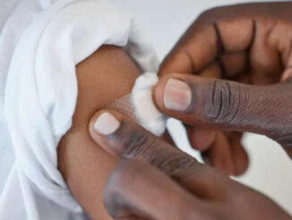 A picture of a person applying a bandage to a patient's arm