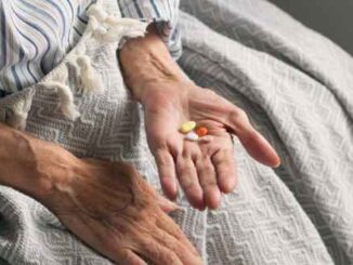 Picture of an old woman holding medication