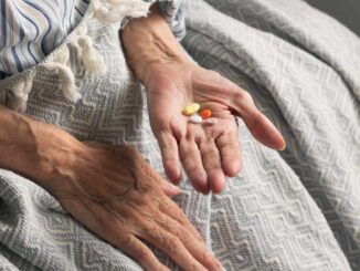 Picture of an old woman holding medication